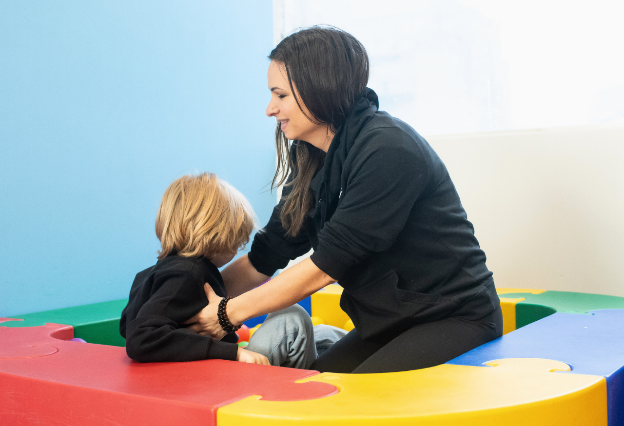 Mother and son smiling outside