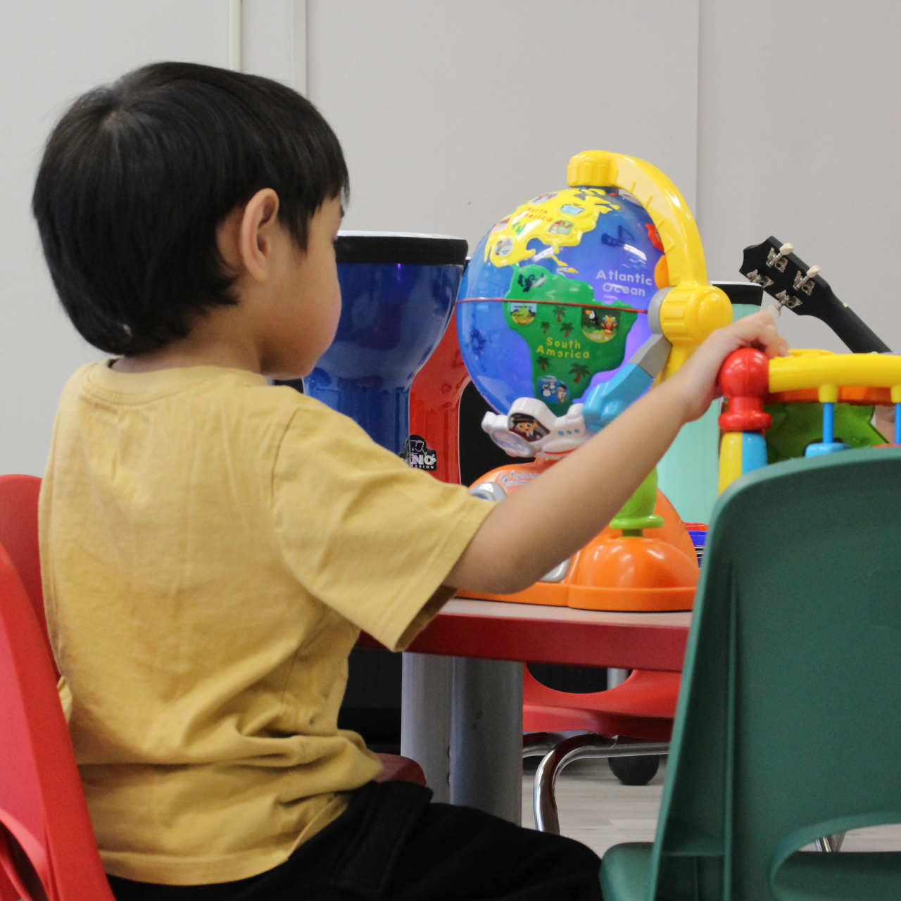 kids in classroom playing with musical instruments
