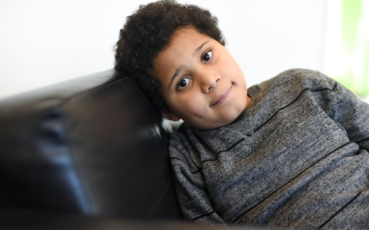 Young boy sitting on a couch