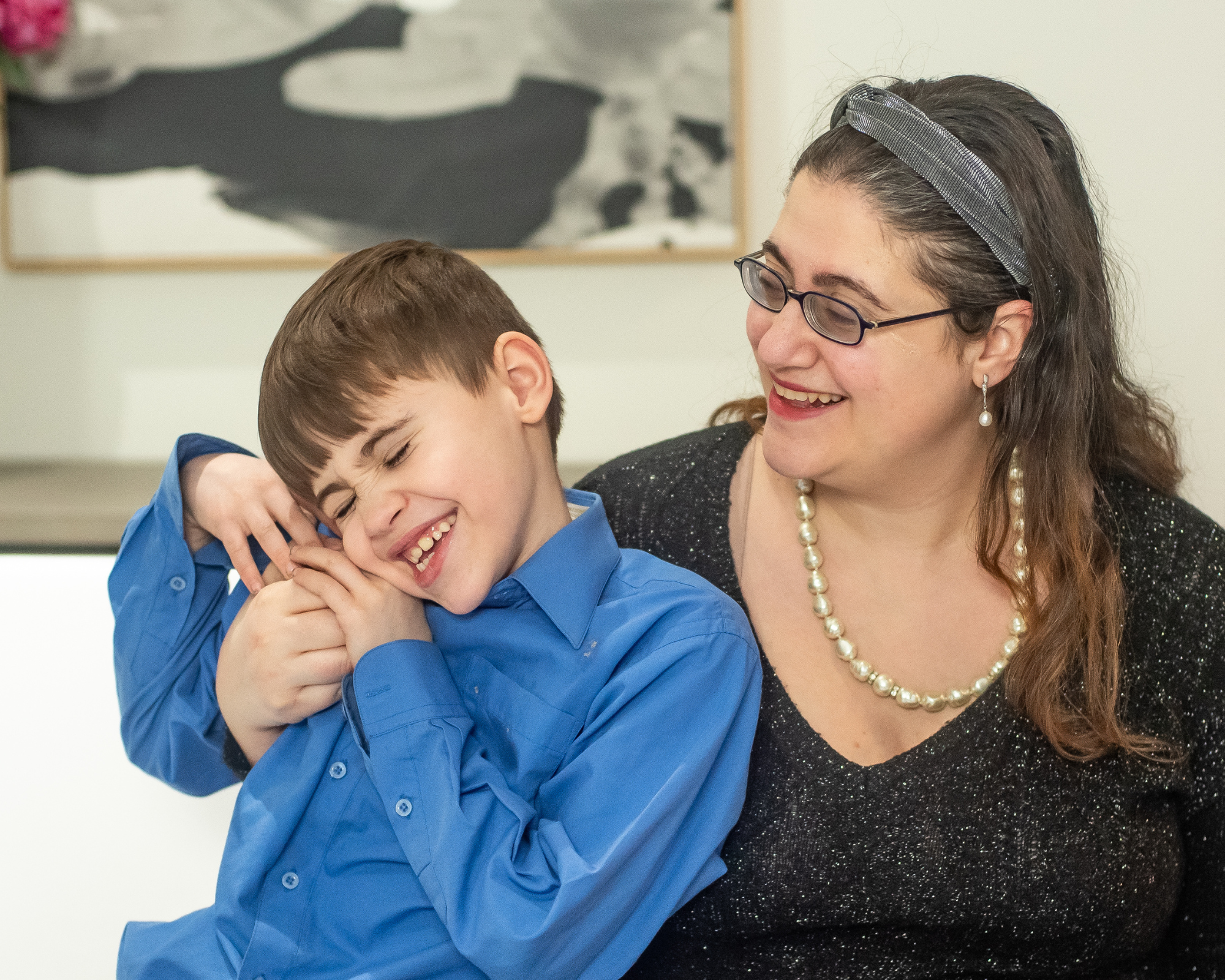 Mother and son smiling outside