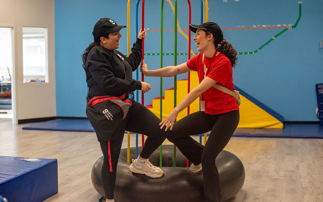 Two staff members talking in playroom