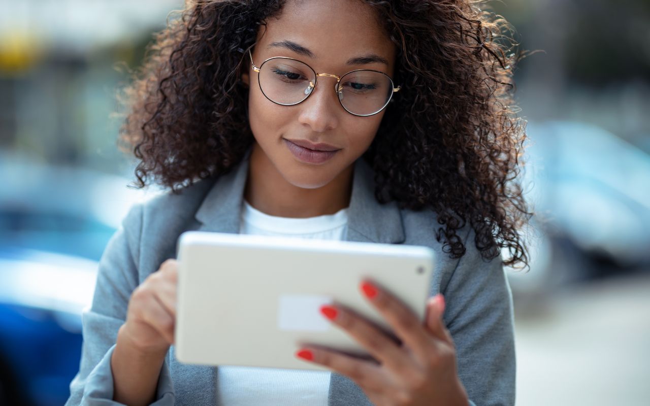 Woman reading news articles on her tablet