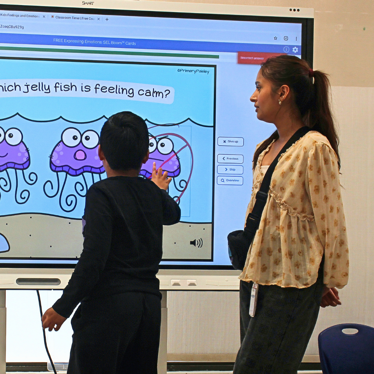 teacher and kid near smartboard learning