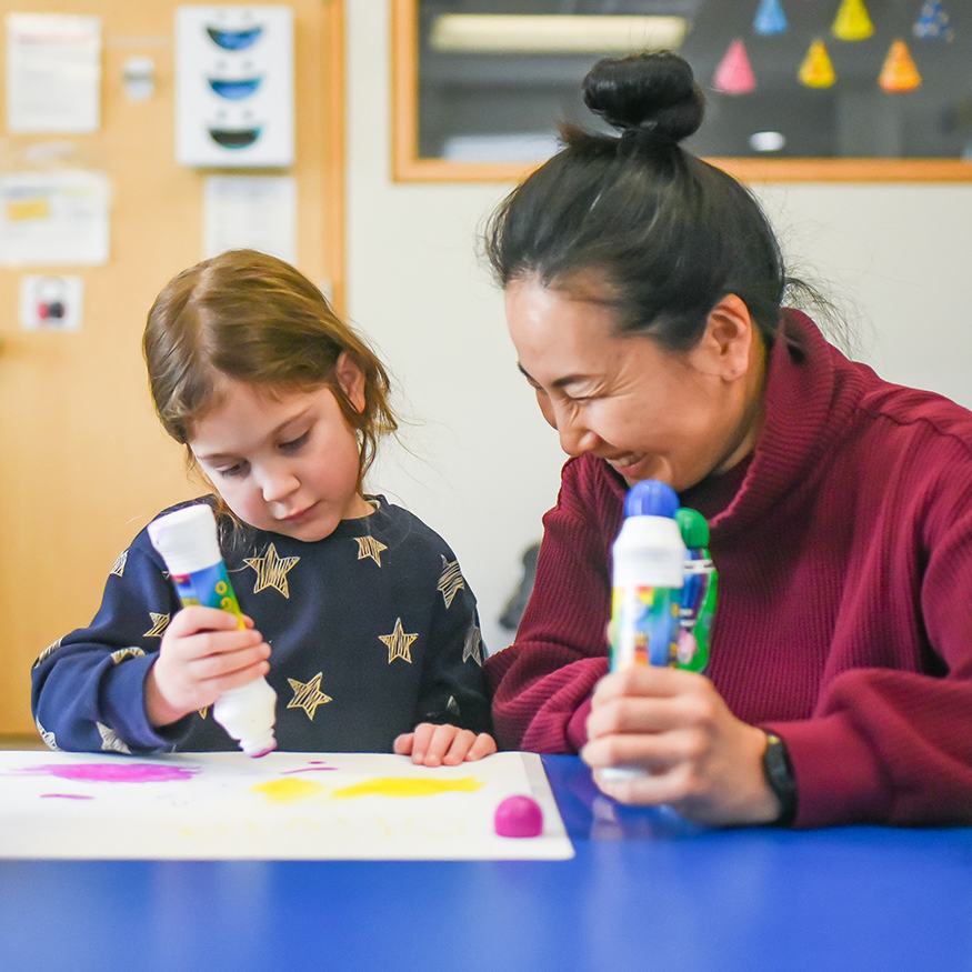 Young girl sitting a desk in a classroom
